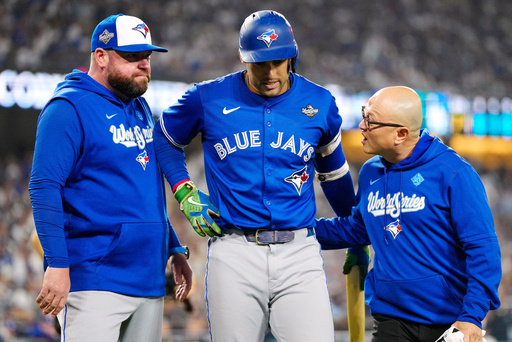 Toronto Blue Jays' George Springer, center, walks off the field as he leaves with an injury with manager John Schneider, left, and first assistant athletic trainer Voon Chong, right, during the seventh inning in Game 3 of baseball's World Series against the Los Angeles Dodgers in Los Angeles, Monday, Oct. 27, 2025. (Frank Gunn/The Canadian Press via AP) Toronto Blue Jays' George Springer, center, walks off the field as he leaves with an injury with manager John Schneider, left, and first assistant athletic trainer Voon Chong, right, during the seventh inning in Game 3 of baseball's World Series against the Los Angeles Dodgers in Los Angeles, Monday, Oct. 27, 2025. (Frank Gunn/The Canadian Press via AP)
