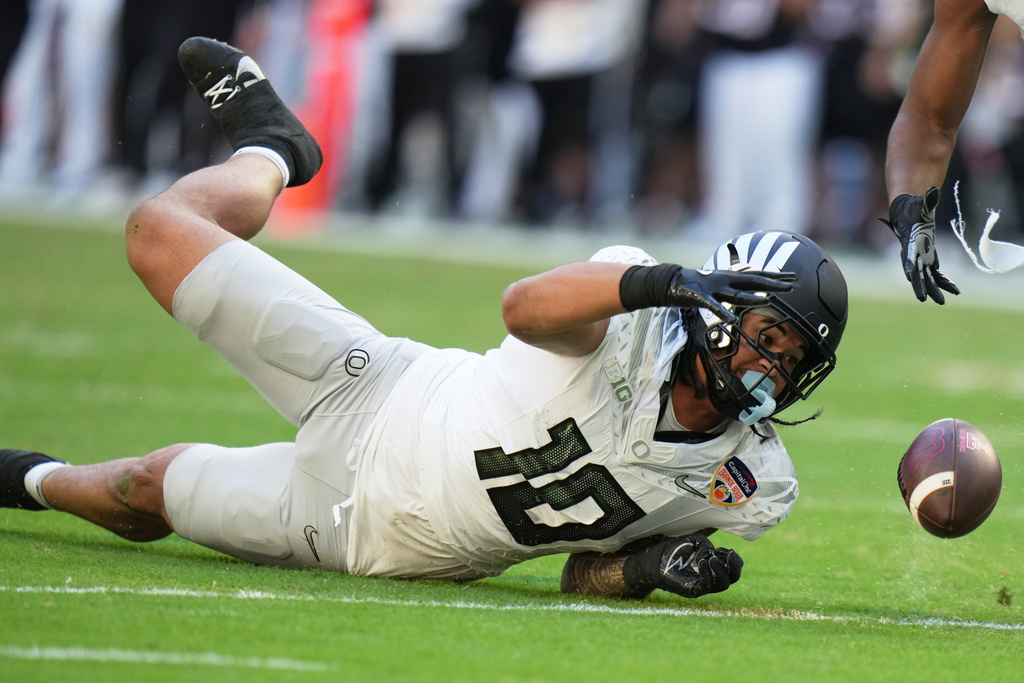 Oregon linebacker Matayo Uiagalelei (10) bobbles the ball before coming up with an interception during the second half of the Orange Bowl College Football Playoff quarterfinal game against Texas Tech, Thursday, Jan. 1, 2026, in Miami Gardens, Fla. (AP Photo/Lynne Sladky)