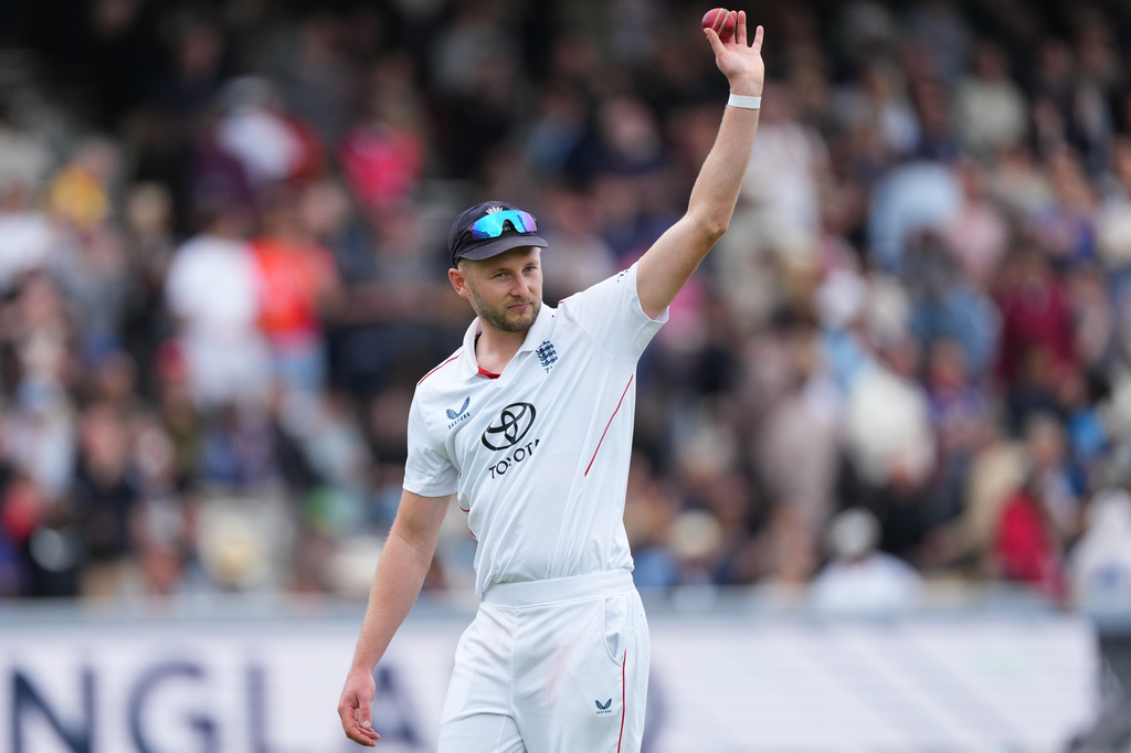 England's Gus Atkinson holds the ball as he leaves the field after bowling out New Zealand's Matt Henry to win the Test match between England and New Zealand at Lord's cricket ground in London, Sunday, June 7, 2026. (AP Photo/Kirsty Wigglesworth)