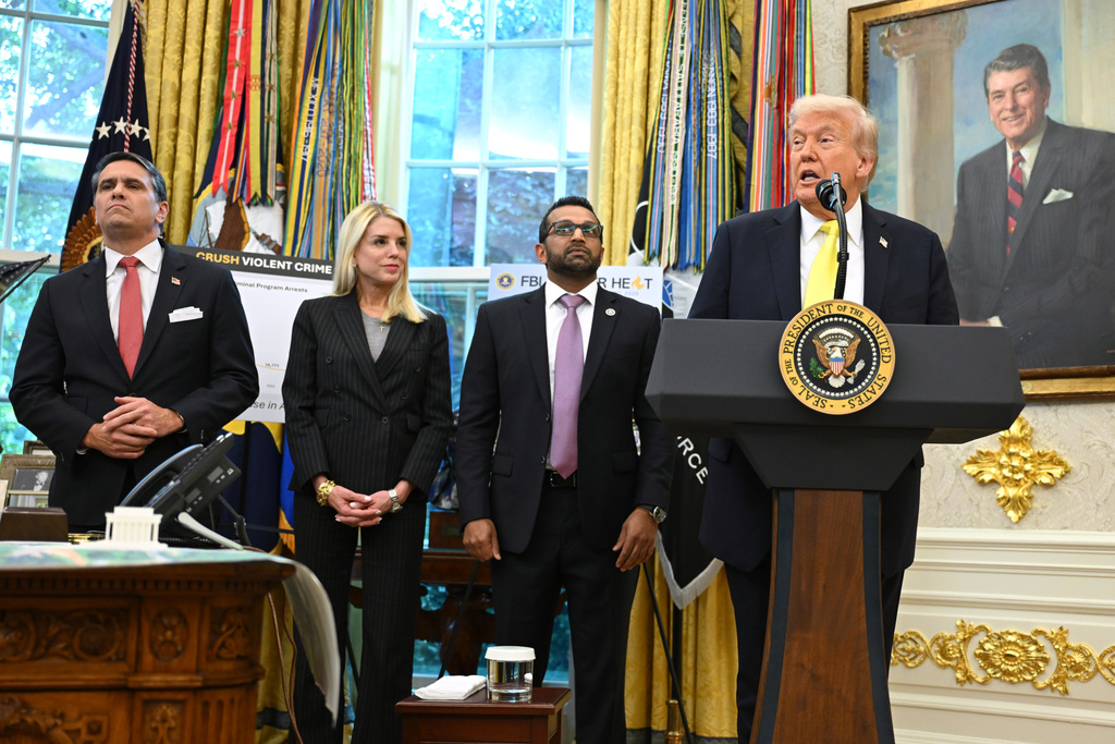 President Donald Trump speaks as FBI Director Kash Patel, Attorney General Pam Bondi, and Deputy Attorney General Todd Blanche listen during an event in the Oval Office at the White House, Wednesday, Oct. 15, 2025, in Washington. (AP Photo/John McDonnell)