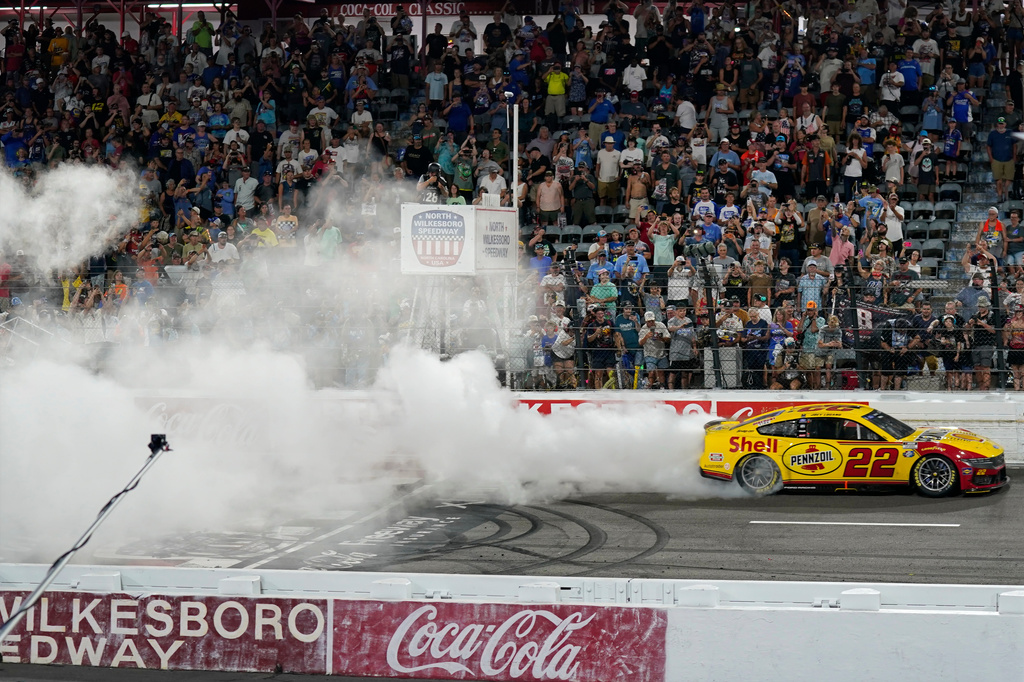 Joey Logano (22) performs a burnout after winning a NASCAR Cup Series auto race in North Wilkesboro, N.C., Sunday, July 19, 2026. (AP Photo/Chuck Burton)