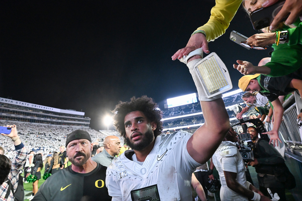 Oregon quarterback Dante Moore (5) celebrates a second overtime win over Penn State during their NCAA college football game, Saturday, Sept. 27, 2025, in State College, Pa. (AP Photo/Barry Reeger)