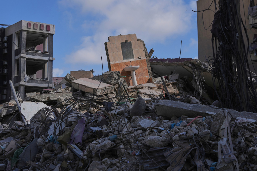 A bathroom mirror and sink remain standing amid the rubble of buildings damaged by Israeli strikes near the Jabal Amel Hospital in the southern port city of Tyre, Lebanon, Thursday, June 18, 2026. (AP Photo/Hassan Ammar)