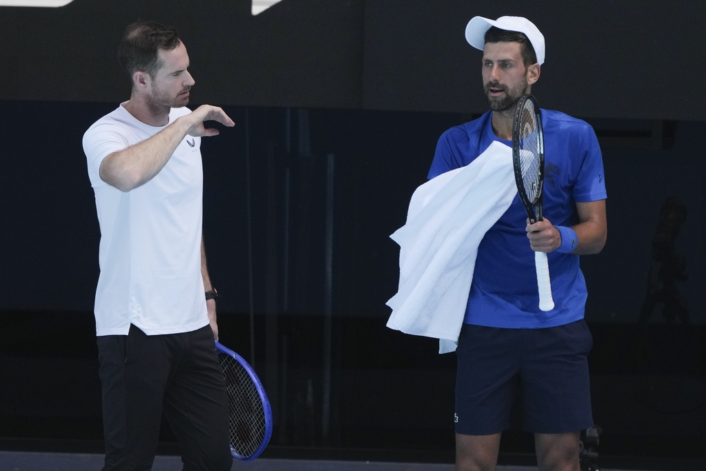 Serbia's Novak Djokovic talks with his coach Andy Murray, left, during a practice session ahead of the Australian Open tennis championship in Melbourne, Australia, Thursday, Jan. 9, 2025. (AP Photo/Mark Baker)