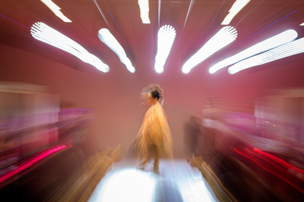 Simona Zamfir strikes a pose on the podium during the SEEN Anonymous Seamstresses Gala, an event organised by the Down Plus Bucharest, an NGO supporting youngsters with Down Syndrome and other intellectual disabilities, in Bucharest, Romania, Wednesday, March 18, 2026, ahead of the World Down Syndrome Day, on March 21. (AP Photo/Andreea Alexandru)
