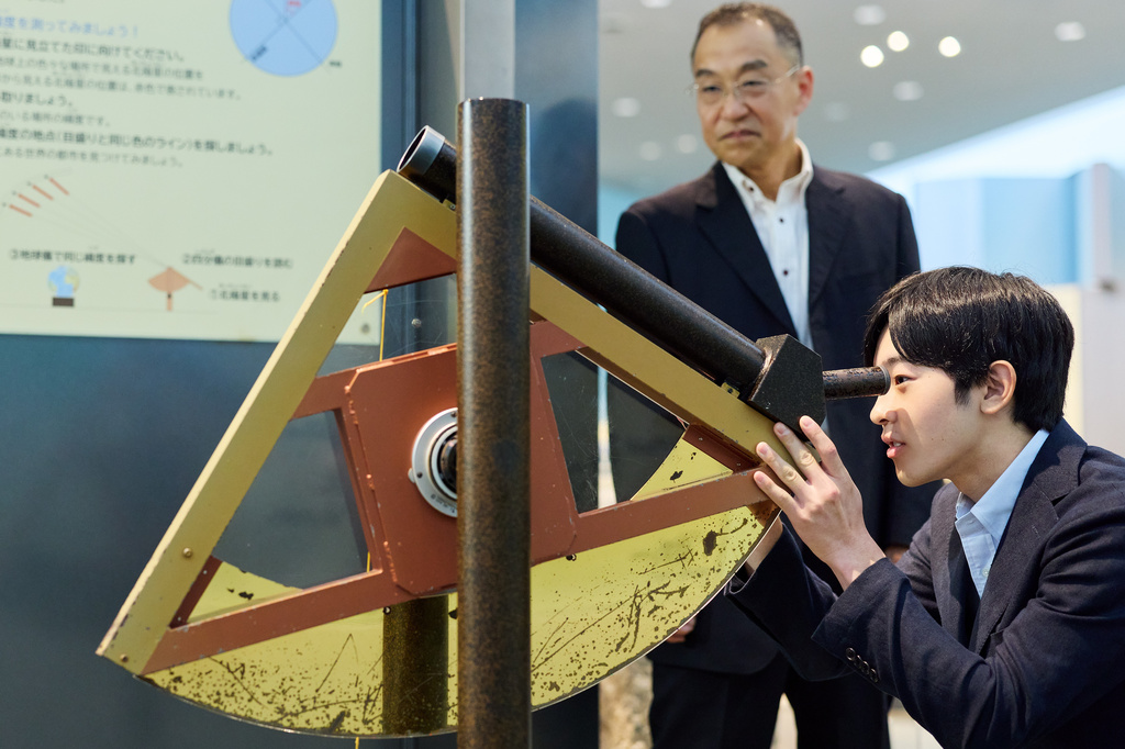 In this photo provided by the Imperial Household Agency of Japan, Japan's Prince Hisahito, right, visits the Science Museum of Map and Survey in Tsukuba, Ibaraki prefecture, Japan, on Aug. 13, 2026, ahead of his 20th birthday on Sept. 6, 2026. (The Imperial Household Agency of Japan via AP)