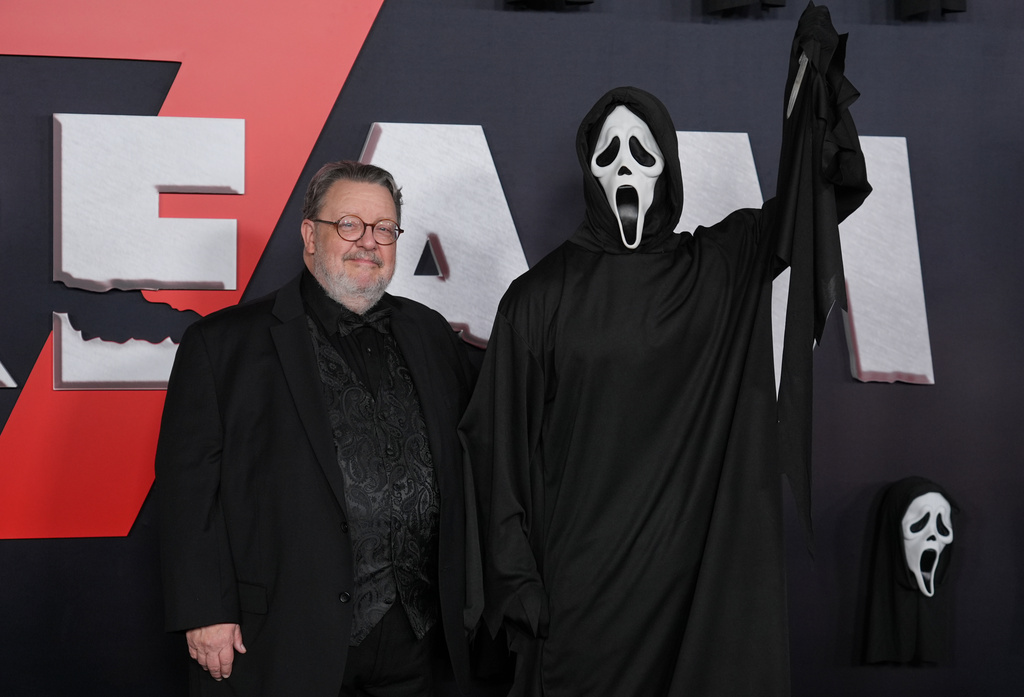 Roger Jackson, left, who provides the voice of the "Scream" franchise's villain "Ghostface," poses with an actor portraying the character at the premiere of the film "Scream 7" on Wednesday, Feb. 25, 2026, at Paramount Studios in Los Angeles. (AP Photo/Chris Pizzello)