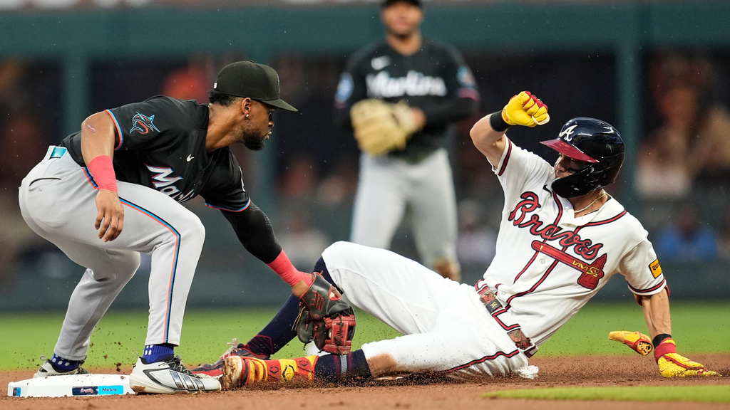 Miami Marlins shortstop Otto Lopez (6) makes the tag on Atlanta Braves' Mauricio Dubón (14) in the second inning of a baseball game, Thursday, Aug. 6, 2026, in Atlanta. (AP Photo/Mike Stewart)