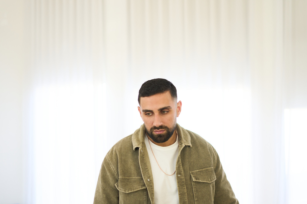 Segev Kalfon, an Israeli hostage who spent two years in captivity in a Hamas tunnel and was released from the Gaza Strip in a ceasefire deal on Oct. 13, looks on at his home in Dimona, southern Israel, Tuesday, Dec. 23, 2025. (AP Photo/Ariel Schalit)