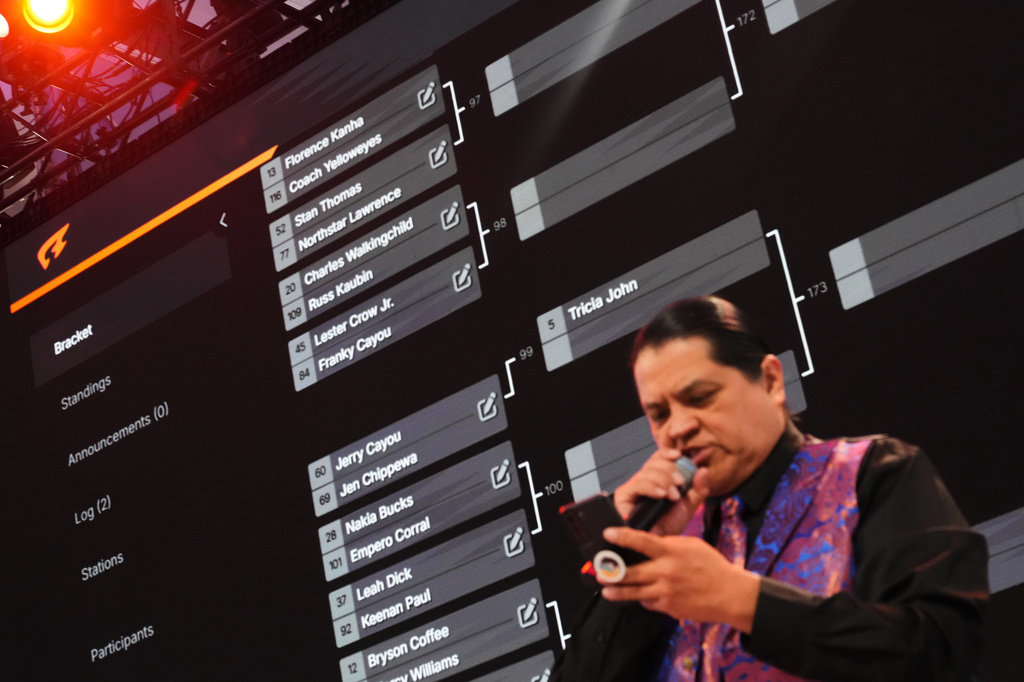A large bracket is shown behind emcee Andre Picard Jr., of the Nez Perce Tribe, during a Stick-Games Tournament hosted by the Puyallup Tribe in partnership with World Cup host city Seattle, Saturday, June 27, 2026, in Tacoma, Wash. (AP Photo/Lindsey Wasson)