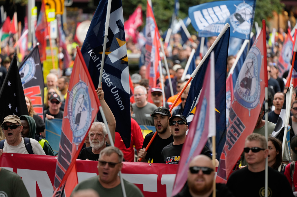 People march to mark International Workers' Day, also known as May Day, in Sydney, Friday, May 1, 2026. (AP Photo/Rick Rycroft)