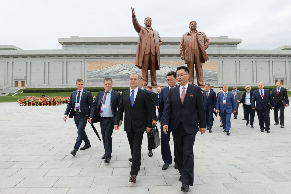 Russian Security Council Deputy Chairman and the head of the United Russia party Dmitry Medvedev, center, leaves after laying flowers to the statues of former North Korean leaders Kim Il Sung and Kim Jong Il on Mansu Hill in Pyongyang, North Korea, on Thursday, Oct. 9, 2025. (Ekaterina Shtukina, Sputnik Pool Photo via AP)