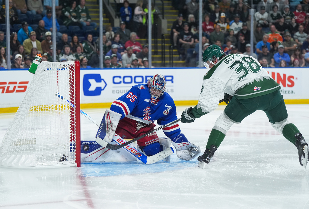 Kitchener Rangers goalie Christian Kirsch (65) stops Everett Silvertips' Shea Busch (38) during the first period of a Memorial Cup hockey game in Kelowna, British Columbia, Monday, May 25, 2026. (Darryl Dyck/The Canadian Press via AP)