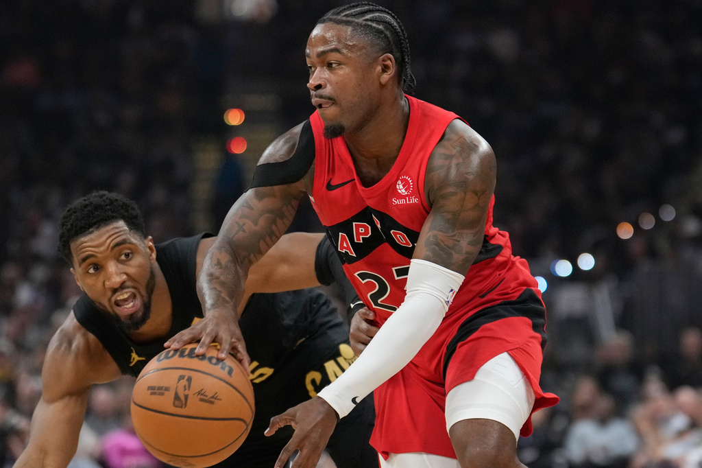 Toronto Raptors guard Jamal Shead (23) drives past Cleveland Cavaliers guard Donovan Mitchell, left, in the first half in Game 7 of a first-round NBA basketball playoffs series in Cleveland, Sunday, May 3, 2026. (AP Photo/Sue Ogrocki)