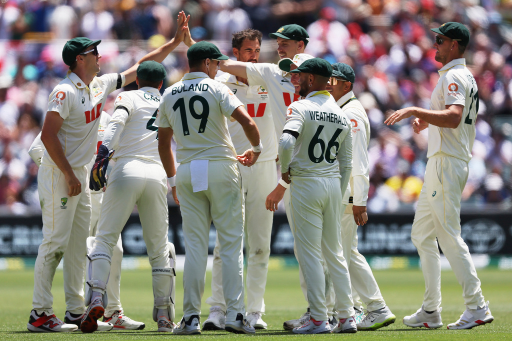 Australian players celebrate the dismissal of England's Jamie Smith during play on the final day of the third Ashes cricket test between England and Australia in Adelaide, Australia, Sunday, Dec. 21, 2025. (AP Photo/James Elsby)