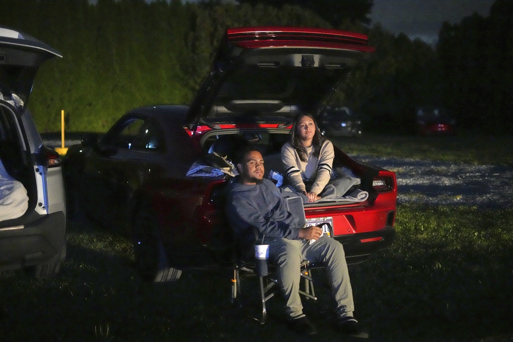 A couple watches the movie "Jaws" at the Shankweiler Drive-In in Orefield, Pa., Friday, Aug. 29, 2025. (AP Photo/Gene J. Puskar)