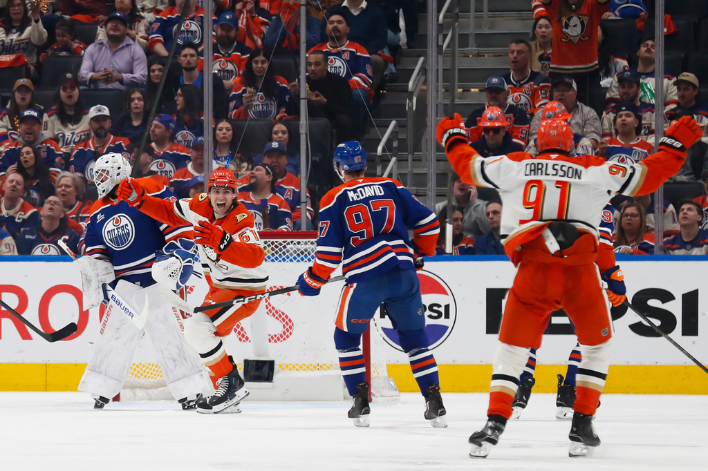 Anaheim Ducks' Cutter Gauthier (61) and Leo Carlsson (91) celebrate a goal against Edmonton Oilers goaltender Connor Ingram (39) during the second period of an NHL hockey playoff game in Edmonton, Alberta, on Wednesday, April 22, 2026. (Codie McLachlan/The Canadian Press via AP)