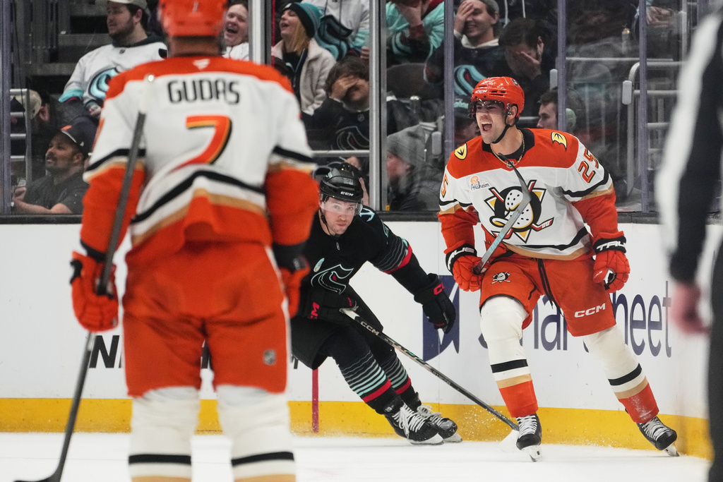 Anaheim Ducks center Ryan Poehling reacts to scoring as Seattle Kraken defenseman Vince Dunn, center, looks on during the first period of an NHL hockey game Friday, Jan. 23, 2026, in Seattle. (AP Photo/Lindsey Wasson)
