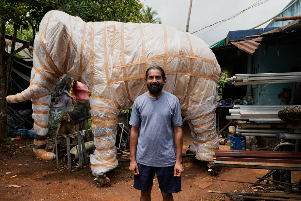 Prasanth Prakashan, a mechanical engineer, poses in front of a robotic elephant at his backyard workshop in Chalakudy, in the southern Indian state of Kerala, Friday, May 22, 2026. (AP Photo/Aijaz Rahi)