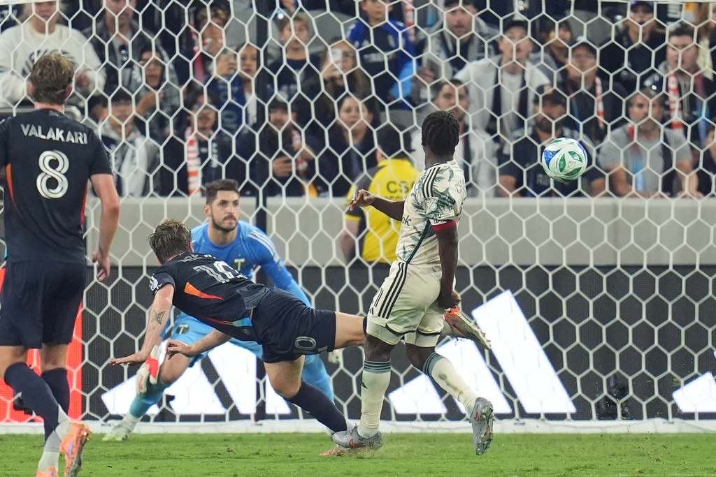 San Diego FC midfielder Anders Dreyer, left, watches his header go in for a goal during the first half of Game 1 in the first round of MLS soccer's Western Conference playoff against Portland Timbers Sunday, Oct. 26, 2025, in San Diego. (AP Photo/Gregory Bull)