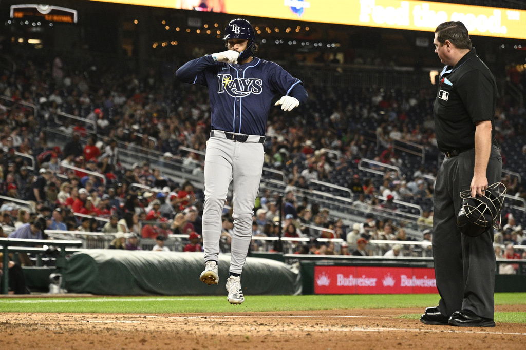 Tampa Bay Rays' Everson Pereira, left, celebrates after his home run near to home plate umpire Derek Thomas, right, during the fifth inning of a baseball game against the Washington Nationals, Friday, Aug. 29, 2025, in Washington. (AP Photo/Nick Wass)