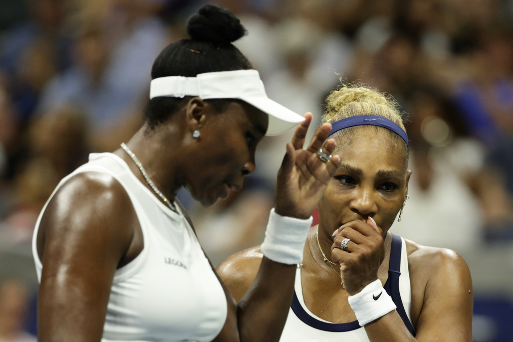 Venus Williams, left, and Serena Williams, of the United States, confer as they play against Hao-Ching Chan, of Taiwan, and Maya Joint, of Australia, during a women's doubles match at the U.S. Open tennis championships, Friday, Sept. 4, 2026, in New York. (AP Photo/Adam Hunger)
