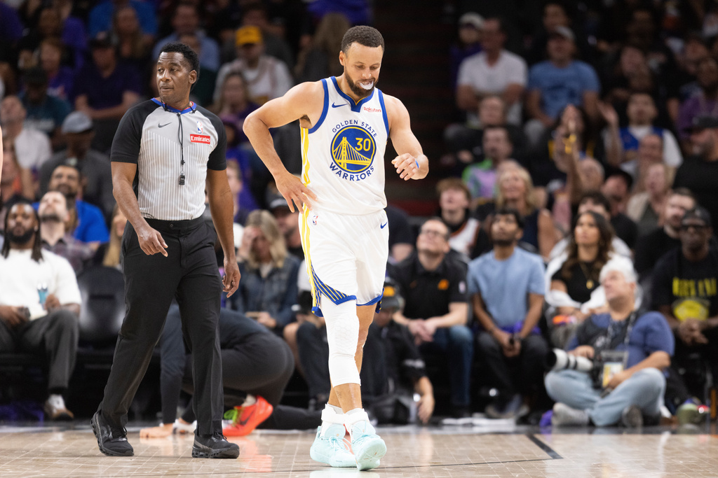 Golden State Warriors guard Stephen Curry (30) walks during the first half of his NBA play-in tournament game against the Phoenix Suns in Phoenix, Ariz., Friday, April 17, 2026. (Stephen Lam/San Francisco Chronicle via AP)