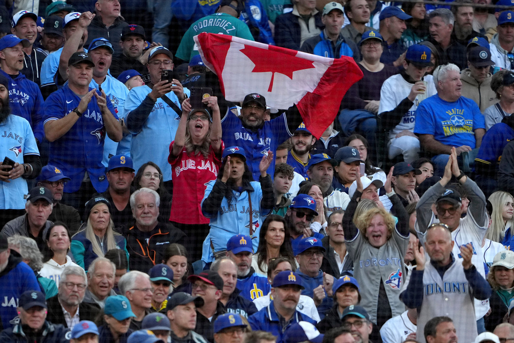 Toronto Blue Jays fans cheer during the third inning in Game 3 of baseball's American League Championship Series against the Seattle Mariners, Wednesday, Oct. 15, 2025, in Seattle. (AP Photo/Lindsey Wasson)