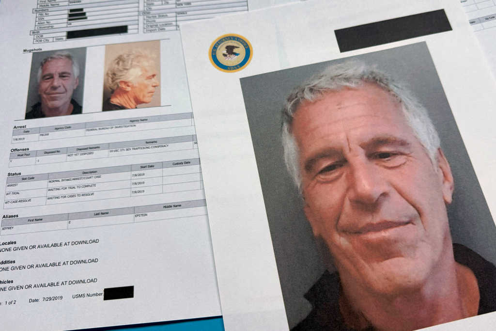 Documents that were included in the U.S. Department of Justice release of the Jeffrey Epstein files are photographed Friday, Jan. 2, 2026. (AP Photo/Jon Elswick)