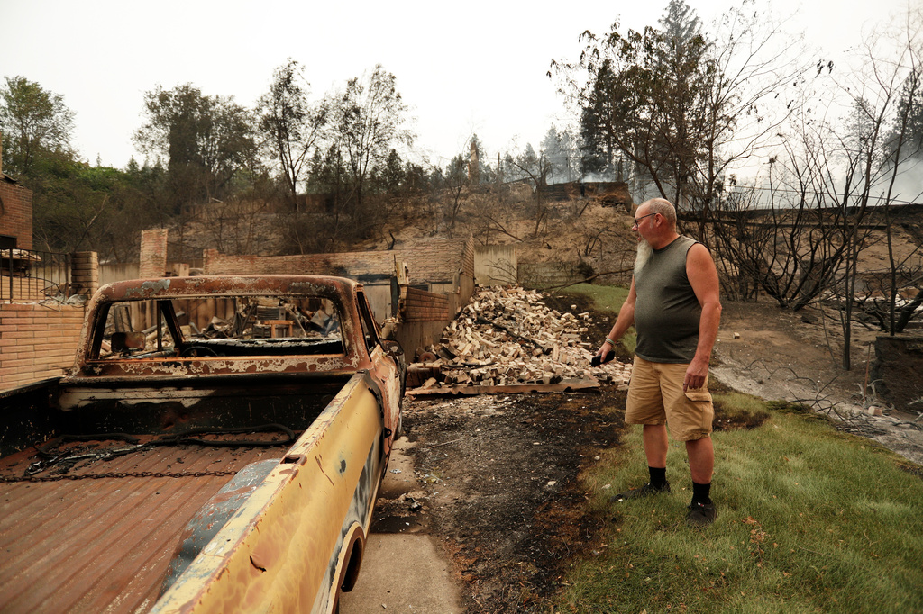 Allen Sather stands in front of his 1968 Chevrolet C20 at the duplex he rented on W. Indian Trail Rd. that burned in a wildfire in Spokane, Wash., Sunday, Aug. 2, 2026. (AP Photo/Young Kwak)