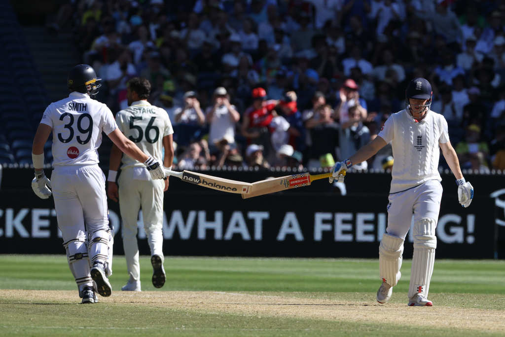 England's Jamie Smith, left and Harry Brook touch bats near the end of their Ashes cricket test match against Australia in Melbourne, Saturday, Dec. 27, 2025. (AP Photo/Hamish Blair)