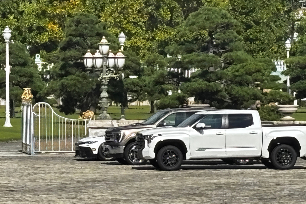 CORRECTS DATE AND LOCATION - A Ford F-150, center, and two other American-made cars sit parked outside the Akasaka Palace, Japan's guest house for visiting foreign leaders, in Tokyo, Japan, Tuesday, Oct. 28, 2025, as President Donald Trump meets Japan's Prime Minister Sanae Takaichi. (AP Photo/Mayuko Ono)