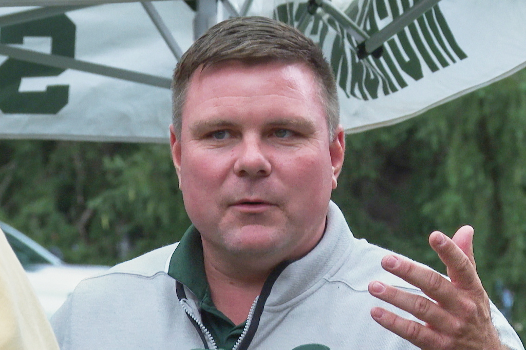 In this image made from video former Sparty mascot, Scott Ferry, talks to friends during a pregame tailgate on Michigan State University campus, Sept. 6, 2025, in East Lansing, Mich. (AP Photo/Mike Householder)