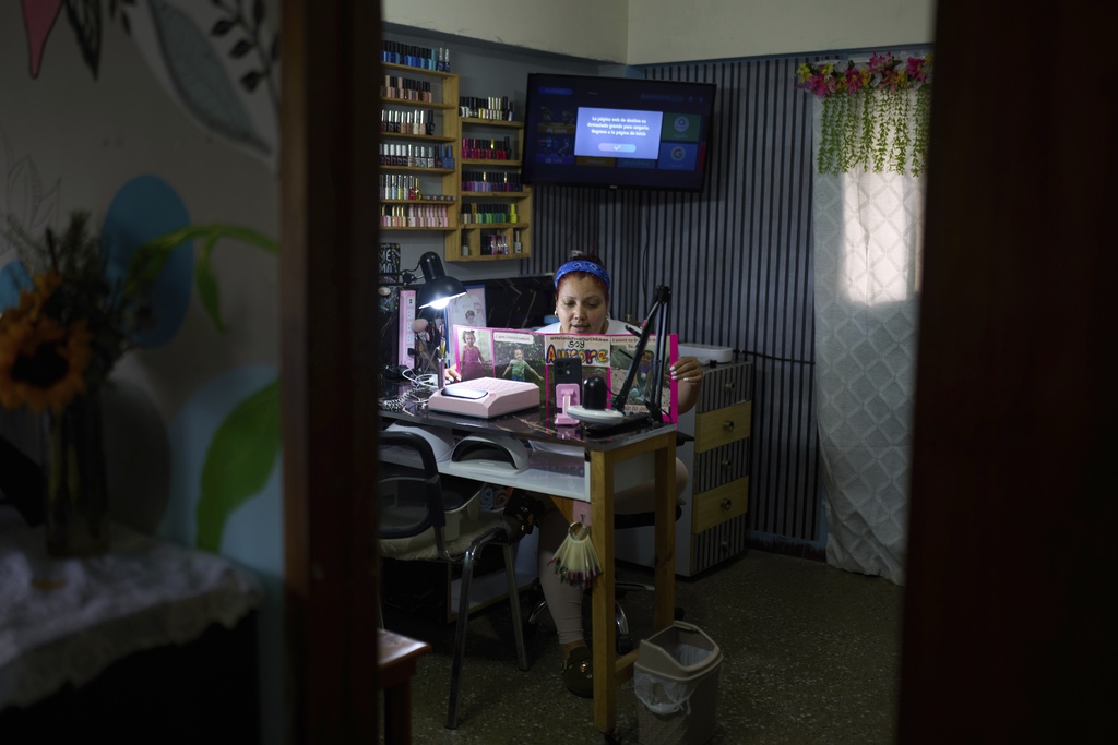 Syntia Caceres records a video for social media about her son who was detained in July in the U.S. and her four-year-old granddaughter Aurore who was subsequently placed in foster care in Georgia state, at her home in Caracas, Venezuela, Thursday, Sept. 4, 2025. (AP Photo/Ariana Cubillos)