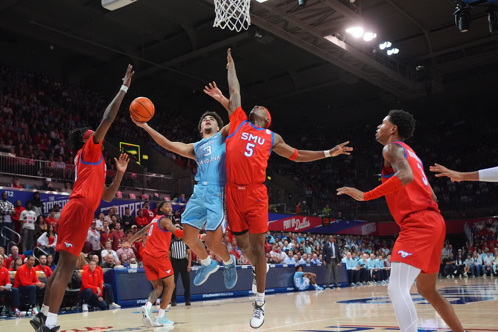 North Carolina guard Derek Dixon (3) drives to the basket against SMU guard Jaron Pierre Jr. (5) during the first half of an NCAA college basketball game Saturday, Jan. 3, 2026, in Dallas. (AP Photo/LM Otero)