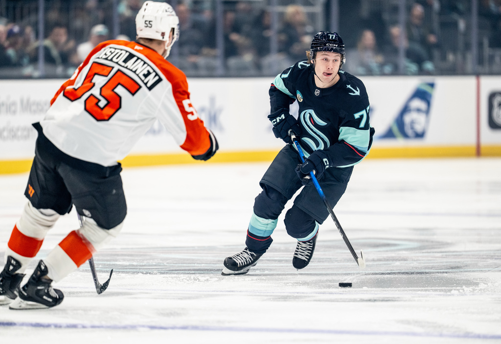 Seattle Kraken forward Berkly Catton skates against Philadelphia Flyers defenseman Rasmus Ristolainen (55) during the first period of an NHL hockey game, Sunday, Dec. 28, 2025, in Seattle. (AP Photo/Stephen Brashear)