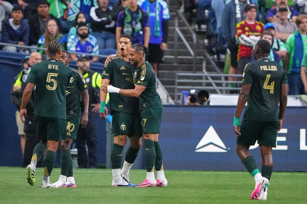Portland Timbers forward Kevin Kelsy celebrates his goal against the Seattle Sounders with midfielder Cole Bassett (17) during the first half of an MLS soccer match, Thursday, July 16, 2026, in Seattle. (AP Photo/Lindsey Wasson)