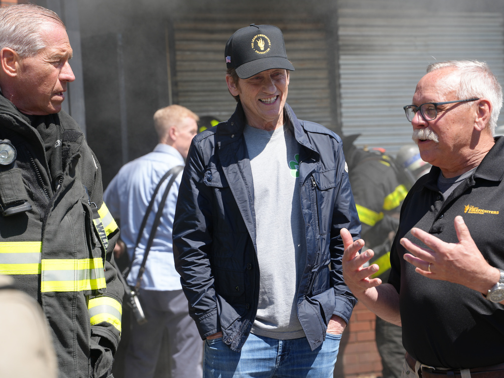 This image provided by Grand Street Media for The Leary Firefighters Foundation shows Leary Firefighters Foundation founder Denis Leary, center, talking with members of the foundation's board of directors, Brian Williams, left, and David Morkal, right, at the 2026 Denis Leary FDNY Firefighter Challenge in New York on May 1, 2026. (Jesse Guma/Grand Street Media for The Leary Firefighters Foundation via AP)