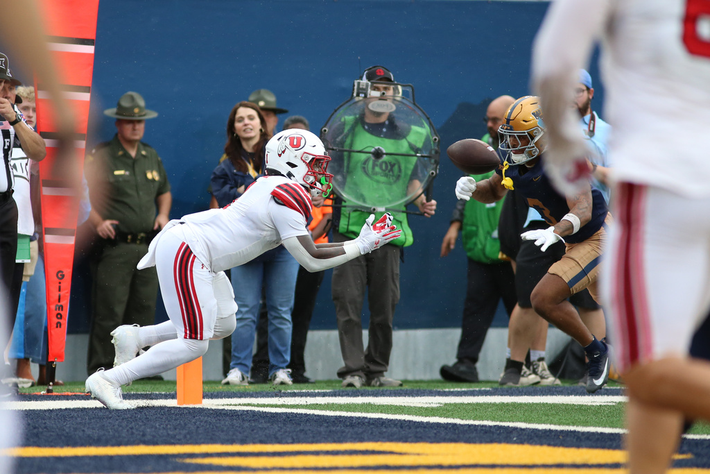 Utah running back Wayshawn Parker (1) makes a catch for a touchdown during the second half of an NCAA college football game against West Virginia, Saturday, Sept, 27, 2025, in Morgantown, W.Va. (AP Photo/ William Wotring)