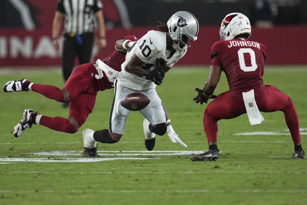Las Vegas Raiders wide receiver Dont'e Thornton Jr. (10) can't make the catch as Arizona Cardinals safety Budda Baker (3) defends during the first half of an NFL preseason football game, Saturday, Aug. 23, 2025, in Glendale. (AP Photo/Rick Scuteri)