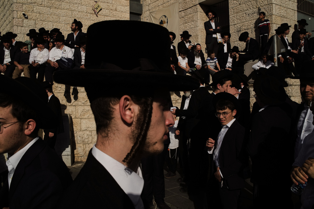 Ultra-Orthodox Jewish men gather for a rally against plans to force them to serve in the Israeli military, in Jerusalem, Thursday, Oct. 30, 2025. (AP Photo/Leo Correa)