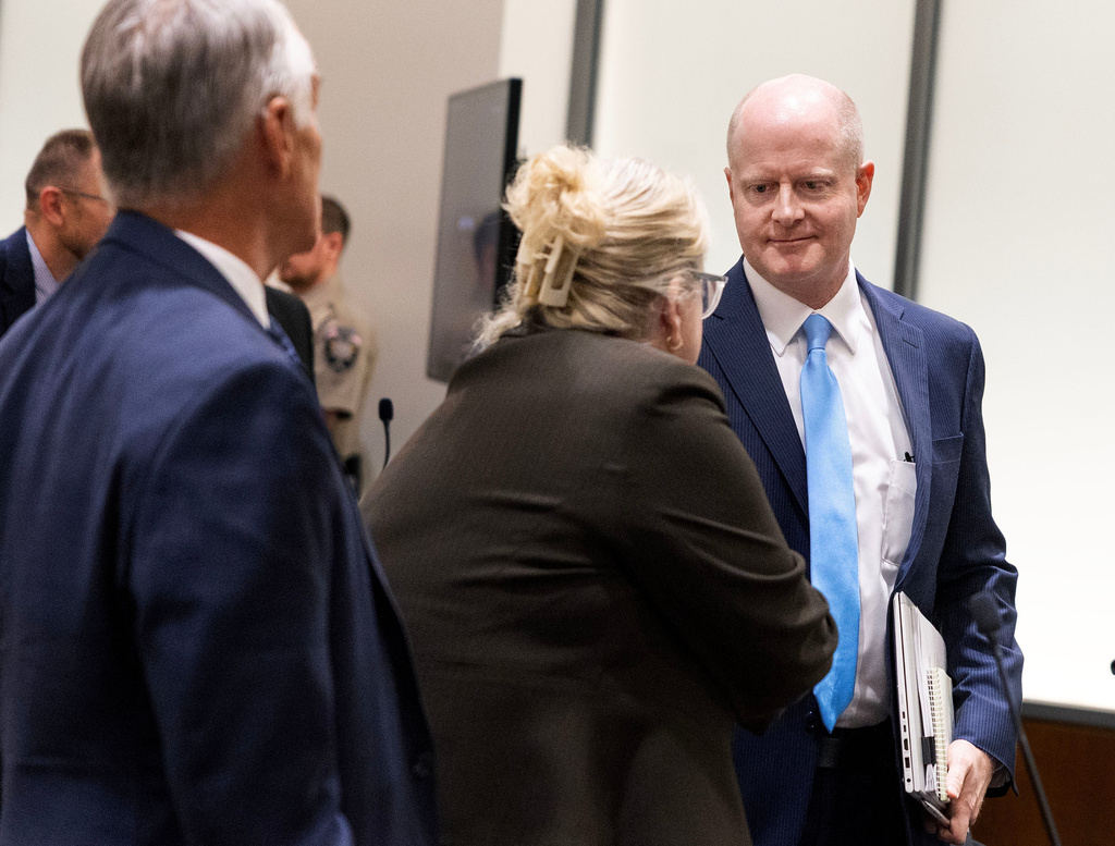 Utah County Attorney's Office prosecutor Chad Grunander, right, meets defense attorney Kathryn Nester, following a waiver hearing for Tyler Robinson, the man accused of killing Charlie Kirk at Utah Valley University, in Utah County Court in Provo, Utah, on Monday, Sept. 29, 2025. (Laura Seitz/The Deseret News via AP, Pool)