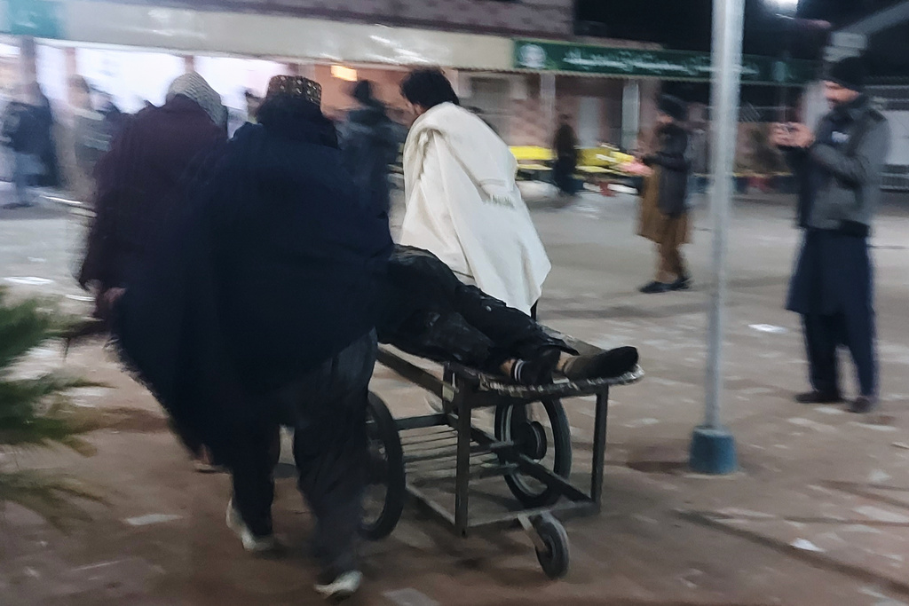 Volunteers transport an injured victim of suicide bombing at a wedding, Friday, Jan. 23, 2026, at a hospital in Dera Ismail Khan, Pakistan. (AP Photo/Kashif Naveed)