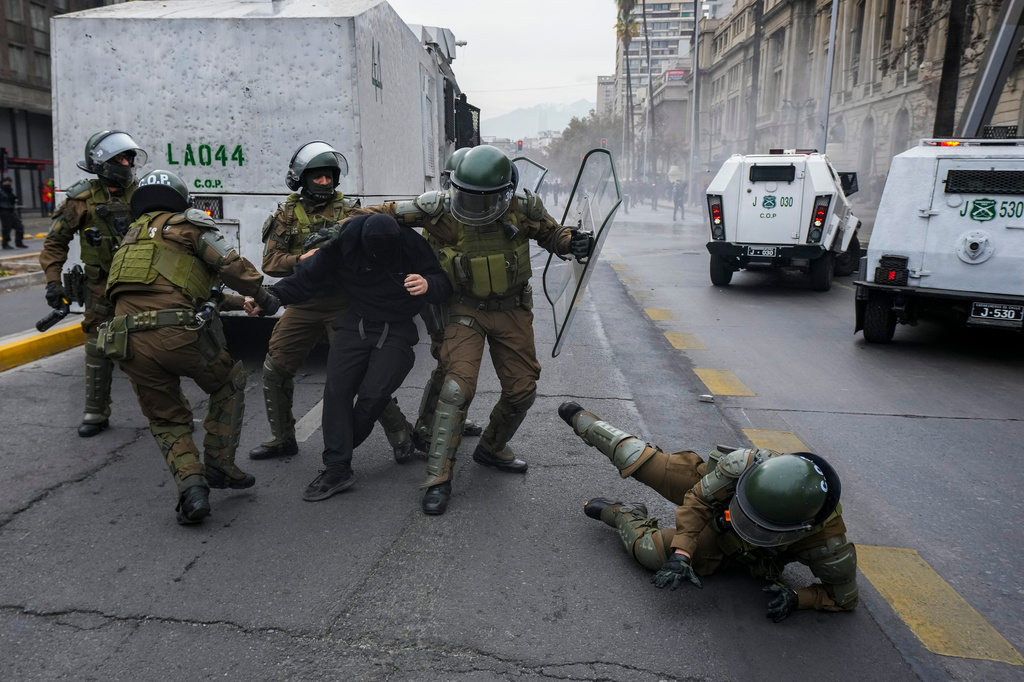 Police detain a student during a protest against the government's proposal to lower the education budget, in Santiago, Chile, Wednesday, June 3, 2026. (AP Photo/Esteban Felix)