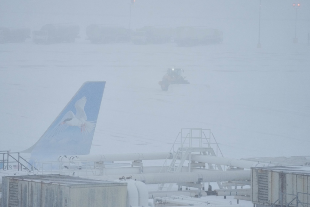 Airport crew plow snow during a winter storm in Philadelphia, Sunday, Jan. 25, 2026. (AP Photo/Matt Rourke)