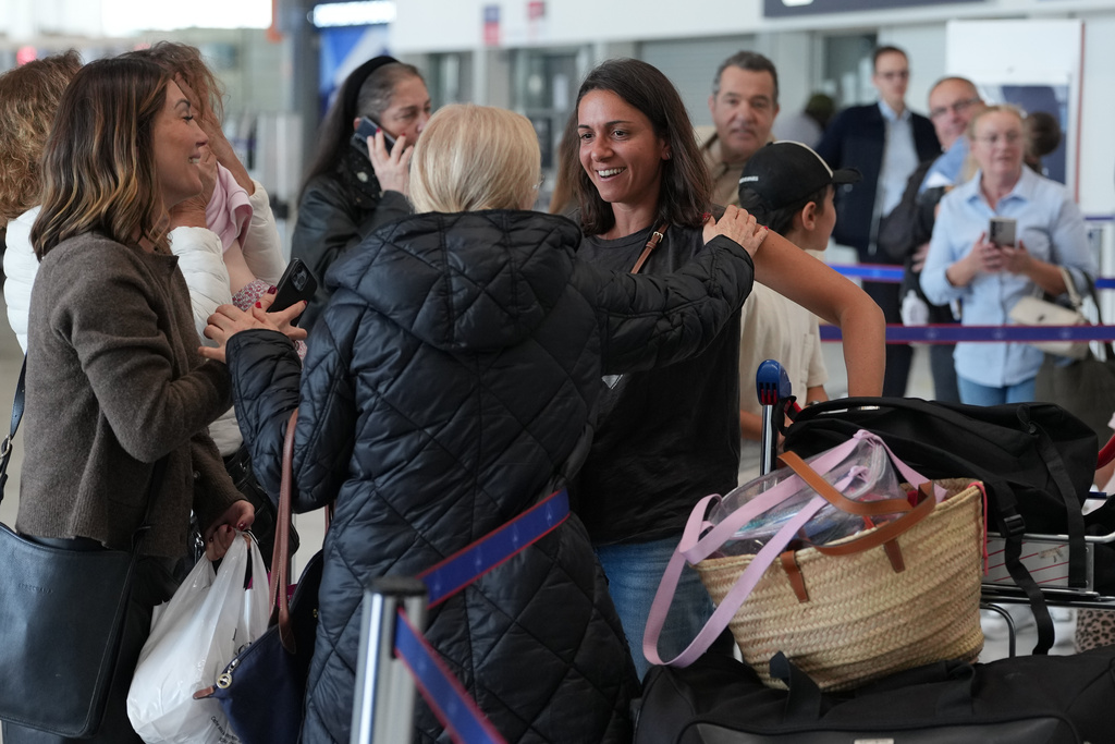 People arrive from Dubai at the Charles de Gaulle international Airport in Roissy, outside Paris, France, Thursday, March 5, 2026. (AP Photo/Thibault Camus)