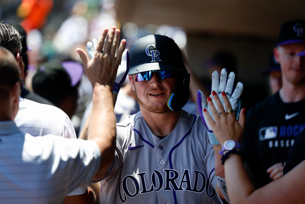 Colorado Rockies' Hunter Goodman is greeted by teammates after hitting a two-run home run during the first inning of a baseball game against the Athletics, Sunday, June 14, 2026, in Las Vegas. (AP Photo/Caroline Brehman)