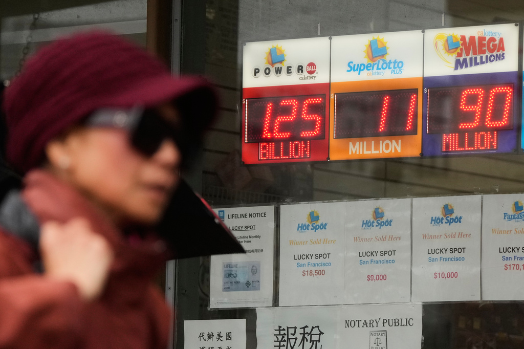 FILE - Jackpot payouts for Powerball, SuperLotto Plus and Mega Millions are displayed at a store, in San Francisco, Dec. 17, 2025. (AP Photo/Jeff Chiu, File)