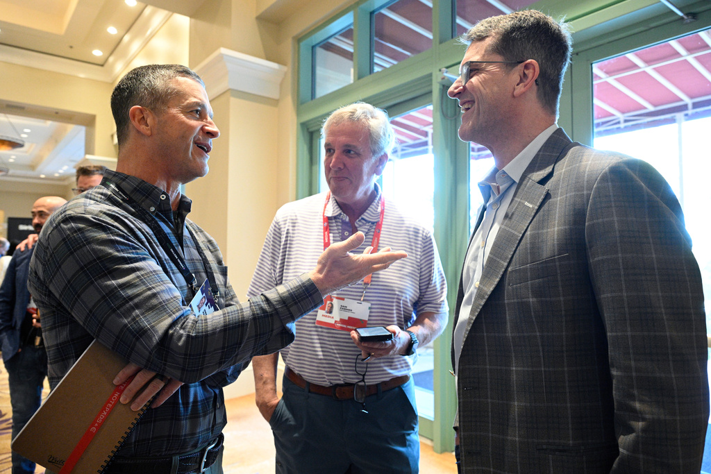 FILE - Baltimore Ravens head coach John Harbaugh, left, and Los Angeles Chargers head coach Jim Harbaugh, right, chat at the NFL football owners meetings, March 25, 2024, in Orlando, Fla. (AP Photo/Phelan M. Ebenhack, File)