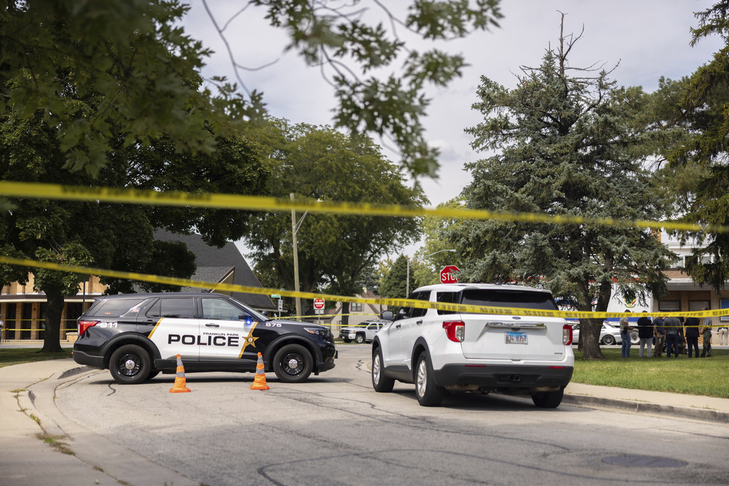 Law enforcement personnel investigate after the Department of Homeland Security said an Immigration and Customs Enforcement agent fatally shot a man in the Franklin Park suburb of Chicago on Friday, Sept. 12, 2025. (Candace Dane Chambers/Chicago Sun-Times via AP)